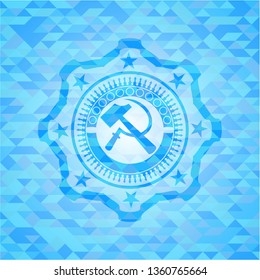 sickle and hammer icon inside sky blue mosaic emblem