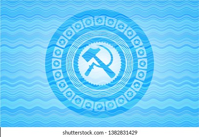 sickle and hammer icon inside sky blue water wave emblem.
