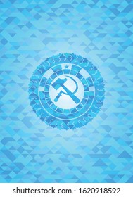 sickle and hammer icon inside sky blue mosaic emblem