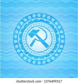 sickle and hammer icon inside water wave representation badge.