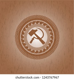 sickle and hammer icon inside wood emblem