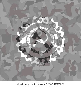 sickle and hammer icon on grey camouflaged pattern