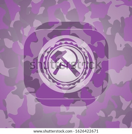 sickle and hammer icon on pink and purple camouflage texture