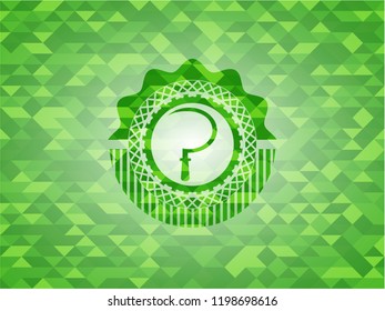 sickle icon inside green emblem with triangle mosaic background