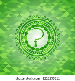 sickle icon inside green emblem. Mosaic background