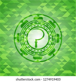 sickle icon inside green mosaic emblem