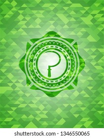 sickle icon inside green mosaic emblem