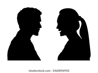 Side profile of young man and young woman talking and looking to each others black silhouettes.	
