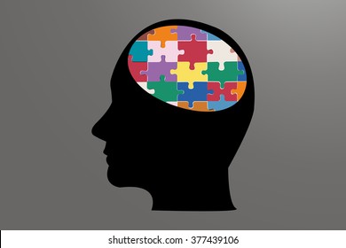 The side silhouette of a man`s  head in black. The brain is made up of colorful puzzle. Everything is on a gray background.