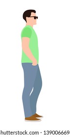 side view full length of a casual young man standing with his hands on his hips and looking away
