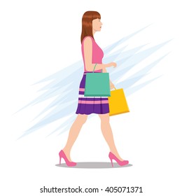 Side View of a Woman Walking with Shopping Bags