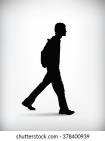 Side view of a young man walking with a backpack