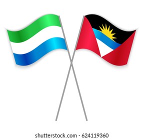 Sierra Leonean and Antiguan crossed flags. Sierra Leone combined with Antigua and Barbuda isolated on white. Language learning, international business or travel concept.