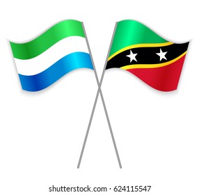 Sierra Leonean and Kittitian crossed flags. Sierra Leone combined with Saint Kitts and Nevis isolated on white. Language learning, international business or travel concept.