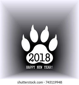 Sign of the new year in the form of a trace of a dog's paw. White against a dark gradient background