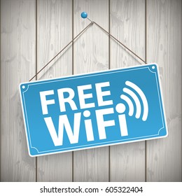 Sign with text Free WiFi on the wooden background.  Eps 10 vector file.