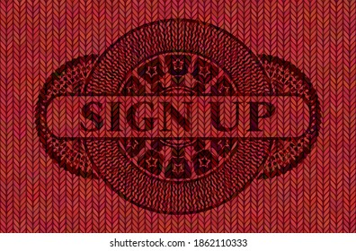 Sign up text inside Red color woolen fabric emblem. Cloth exquisite background. Artistic illustration. 