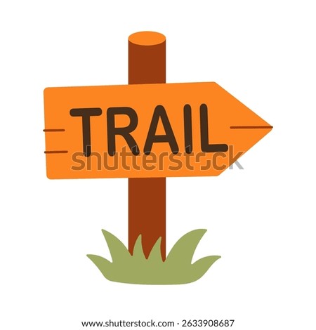 A sign that says Trail is on a wooden post. The sign is orange and has a green arrow pointing to the right