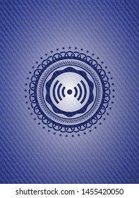signal icon inside badge with denim texture