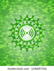 signal icon inside green emblem with triangle mosaic background