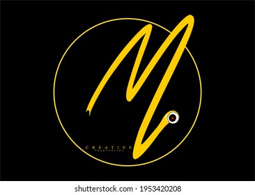 Signature Circle in the form of Letter M which is Gold colored. logotype with eye ornament