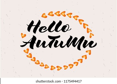 Signature "Hello autumn" with orange heart wreath on pink textured background. Lettering typography poster. Vector illustration.  Template for personal card, company logotype or invitation card.