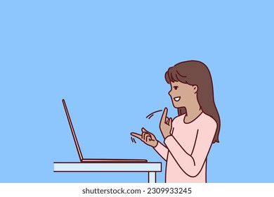 Silent teenage girl using laptop and sign language making video call to friends or school teacher for distance learning. Silent child gesturing standing near computer while learning to communicate