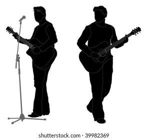 Silhouette of acoustic guitarist playing his instrument and singing