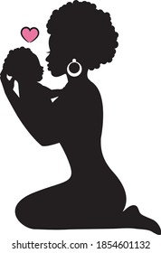 silhouette african woman sitting on her knees and holding a small child in her arms