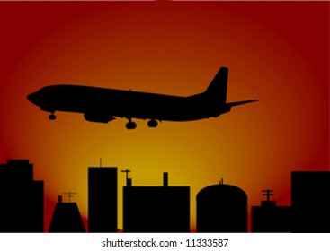 silhouette airplane and big city