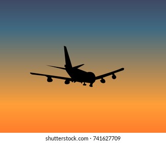 Silhouette of an airplane on sunset sky