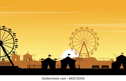 Silhouette of amusement park with orange sky scenery