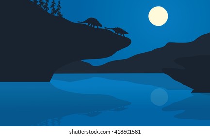 Silhouette of ankylosaurus at the night in cliff