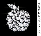 Silhouette of an apple lined with bright diamonds and crystals. On a black background with a bright shine. 3d realistic vector illustration.