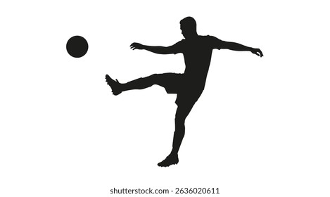 Silhouette of an athletic man kicking a ball in the air playing soccer