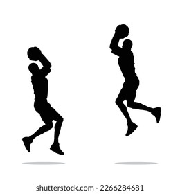 silhouette of a basketball player is about to throw the ball into the hoop