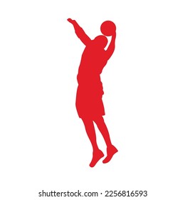 silhouette of a basketball player carrying the ball is throwing it into the hoop