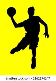 Silhouette of a basketball player in motion with the ball.