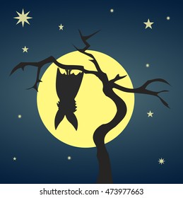 Silhouette bat hanging on a dry tree 