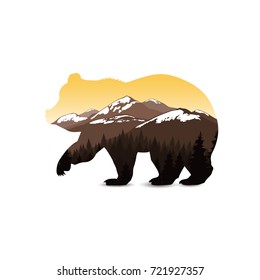 Silhouette of bear with coniferous forest. Seven snowy peaks. Sunset.  