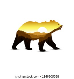Silhouette of bear with mountain landscape.