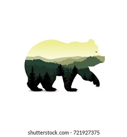 Silhouette of bear with mountain landscape.