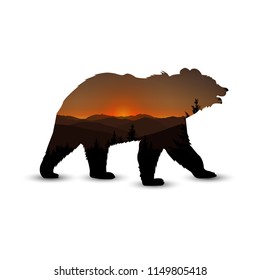  Silhouette of bear with panorama of mountain  and coniferous trees. Brown shades. Sunset.