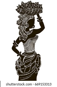 
Silhouette of a beautiful African woman with a basket on her head