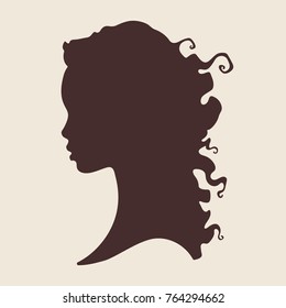 Silhouette of beautiful curly african woman in profile isolated vector illustration. Beauty salon or hair product logo design.