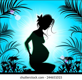 Silhouette of a beautiful pregnant woman on a background of blue sunny sky