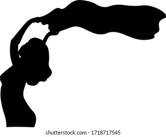 A silhouette of a beautiful woman who holds a flag above her head. Fight for women's rights concept.