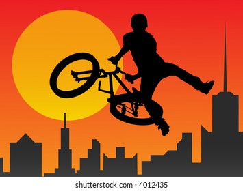 Silhouette of the bicyclist executing a stunt