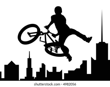 Silhouette of the bicyclist executing a stunt