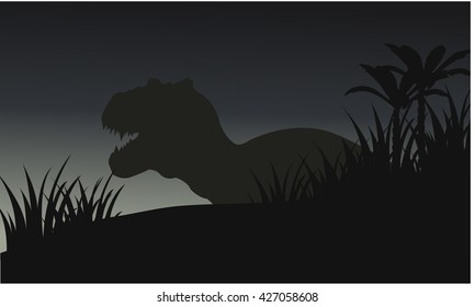 Silhouette of big Tyrannosaurus with grass and blue backgrounds